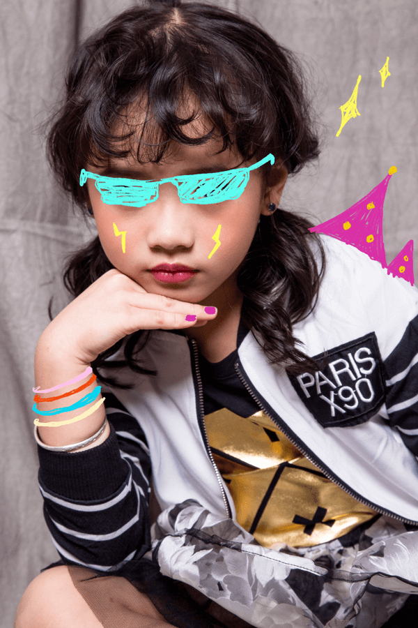 YAWN brand lifestyle image featuring child with colorful outfit and playful illustrations