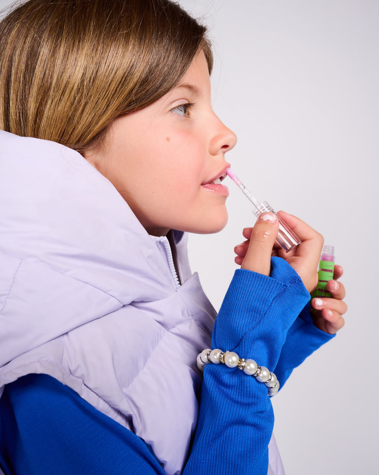 Profile photo of a girl applying YAWN lip gloss