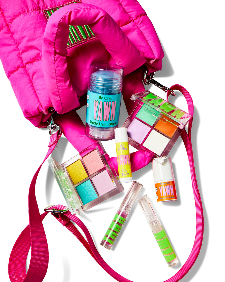 Pink puffy bag with YAWN products spilling out.